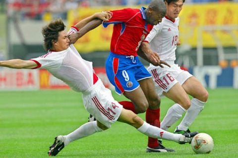 Costa Rica's Paulo Wanchope (C) is challenged by China's Li Weifeng (L) and Li Xiaopeng in their Group C match at the 2002 FIFA World Cup Korea/Japan in Gwangju, 04 June 2002.  It is the first opening round match for both sides.     AFP PHOTO/Vanderlei ALMEIDA