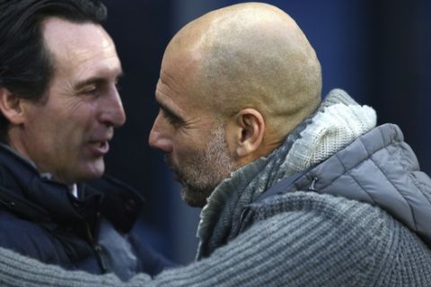 Manchester City manager Josep Guardiola, right, greets Arsenal's head coach Unai Emery before the English Premier League soccer match between Manchester City and Arsenal at Etihad stadium in Manchester, England, Sunday, Feb. 3, 2019. (AP Photo/Dave Thompson)