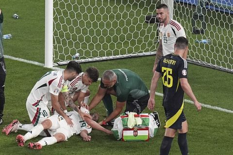 Hungary's Barnabas Varga (19) is attended after an injury during a Group A match between Scotland and Hungary at the Euro 2024 soccer tournament in Stuttgart, Germany, Sunday, June 23, 2024. (AP Photo/Ariel Schalit)