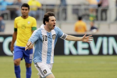 Argentina's Lionel Messi celebrates his game-winning goal - his third of the game - against Brazil during their international friendly soccer match in East Rutherford, New Jersey, June 9, 2012.  REUTERS/Eduardo Munoz (UNITED STATES  - Tags: SPORT SOCCER)