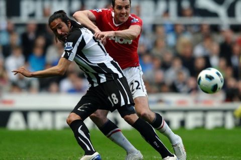 Newcastle United's Spanish defender Sanchez Jose Enrique (L) and Manchester United's Irish defender John O'Shea compete for the ball during the English Premier League football match between Newcastle United and Manchester United at St James' Park, Newcastle, north east England, on April 19, 2011. AFP PHOTO/PAUL ELLIS - FOR EDITORIAL USE ONLY Additional licence required for any commercial/promotional use or use on TV or internet (except identical online version of newspaper) of Premier League/Football League photos. Tel DataCo +44 207 2981656. Do not alter/modify photo. (Photo credit should read PAUL ELLIS/AFP/Getty Images)