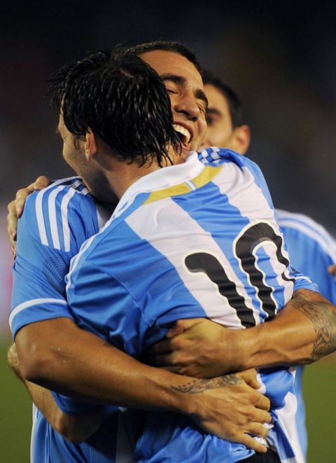 Argentine footballer Lionel Messi (R) congratulates teammate Nicolas Otamendi for scoring the only goal during a football match in Kolkata on September 2, 2011. Argentina's football team, lead by the newly elected captain Lionel Messi, beat Venezuela 1-0 in the first ever FIFA Friendly International Match on the Indian subcontinent. AFP PHOTO/ Dibyangshu SARKAR (Photo credit should read DIBYANGSHU SARKAR/AFP/Getty Images)