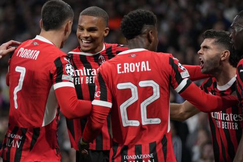 AC Milan's Malick Thiaw, center, celebrates after scoring the opening goal against Real Madrid during the Champions League opening phase soccer match at the Santiago Bernabeu stadium in Madrid, Spain, Tuesday, Nov. 5, 2024. (AP Photo/Manu Fernandez)