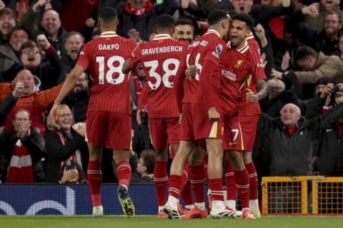 Liverpool players celebrate after Liverpool's Cody Gakpo scored the opening goal during the English Premier League soccer match between Liverpool and Manchester City at Anfield Stadium, Liverpool, England, Sunday Dec. 1, 2024. (AP Photo/Ian Hodgson)