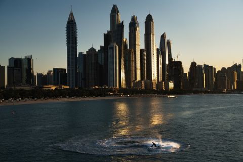 A jet ski races around in a circle as the Dubai Marina is seen in the background in Dubai, United Arab Emirates, Saturday, Dec. 21, 2019. (AP Photo/Jon Gambrell)