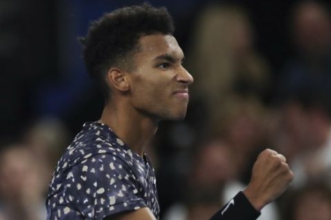 Felix Auger-Aliassime of Canada clenches his fist after scoring a point against Stefanos Tsitsipas of Greece in the men's singles final of the Open 13 Provence tennis tournament in Marseille, southern France, Sunday, Feb. 23, 2020. (AP Photo/Daniel Cole)