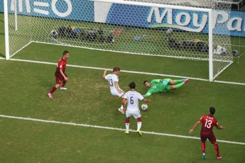 SALVADOR, BRAZIL - JUNE 16:  Thomas Mueller of Germany scores his team's fourth goal and completes his hat trick past Rui Patricio of Portugal during the 2014 FIFA World Cup Brazil Group G match between Germany and Portugal at Arena Fonte Nova on June 16, 2014 in Salvador, Brazil.  (Photo by Francois Xavier Marit - Pool/Getty Images)