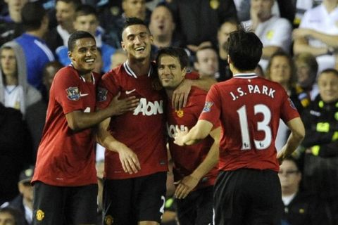 Manchester United's Michael Owen (2nd R) celebrates scoring with teammates during their English League Cup soccer match against Leeds United in Leeds, northern England September 20, 2011. REUTERS/Nigel Roddis (BRITAIN - Tags: SPORT SOCCER) FOR EDITORIAL USE ONLY. NOT FOR SALE FOR MARKETING OR ADVERTISING CAMPAIGNS. NO USE WITH UNAUTHORIZED AUDIO, VIDEO, DATA, FIXTURE LISTS, CLUB/LEAGUE LOGOS OR "LIVE" SERVICES. ONLINE IN-MATCH USE LIMITED TO 45 IMAGES, NO VIDEO EMULATION. NO USE IN BETTING, GAMES OR SINGLE CLUB/LEAGUE/PLAYER PUBLICATIONS