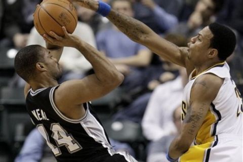 San Antonio Spurs guard Gary Neal, left, has his shot blocked by Indiana Pacers guard Brandon Rush (25) during the third quarter of an NBA basketball game in Indianapolis, Friday, Jan. 7, 2011. San Antonio won 90-87. (AP Photo/Darron Cummings)