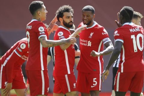 Liverpool's Mohamed Salah, third from left, celebrates with his teammates after scoring his side's opening goal during the English Premier League soccer match between Liverpool and Newcastle United at Anfield stadium in Liverpool, England, Saturday, April 24, 2021. (David Klein, Pool via AP)