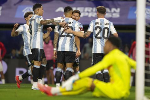 Argentina's Lionel Messi embraces Lautaro Martinez after he scored the his side's opening goal against Peru during a FIFA World Cup 2026 qualifying soccer match at La Bombonera stadium in Buenos Aires, Argentina, Tuesday, Nov. 19, 2024. (AP Photo/Natacha Pisarenko)