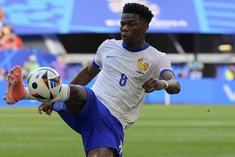 Aurelien Tchouameni of France controls the ball during a round of sixteen match between France and Belgium at the Euro 2024 soccer tournament in Duesseldorf, Germany, Monday, July 1, 2024. (AP Photo/Martin Meissner)