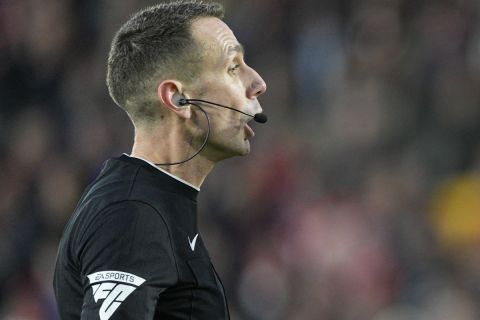 Referee David Coote has words with Nathan Collins of Brentford during the English Premier League soccer match between Brentford and Aston Villa, at the Gtech Community Stadium in London, Sunday, Dec. 17, 2023. (AP Photo/Dave Shopland)