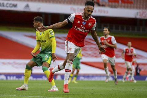 Arsenal's Pierre-Emerick Aubameyang celebrates after scoring his side third goal Bduring the English Premier League soccer match between Arsenal and Norwich City at the Emirates Stadium in London, England, Wednesday, July 1, 2020. (Richard Heathcote/Pool via AP)