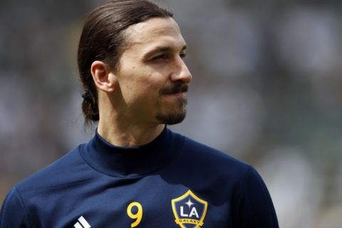 FILE - In this March 31, 2018, file photo, Los Angeles Galaxy's Zlatan Ibrahimovic, of Sweden, stands on the field during warmups before an MLS soccer match against the Los Angeles FC in Carson, Calif. The 37-year-old Ibrahimovic is returning to the Galaxy for a second season despite gathering interest from European clubs. The Swedish superstar was disappointed in the Galaxys overall performance last year despite his own strong debut in Major League Soccer. (AP Photo/Jae C. Hong, File)