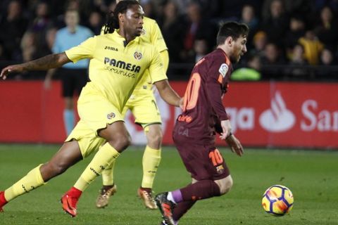 Barcelona's Lionel Messi, right, drives the ball followed with Villarreal's Ruben Semedo, during the Spanish La Liga soccer match between Villarreal and FC Barcelona at the Ceramica stadium in Villarreal, Spain, Sunday, Dec. 10, 2017. (AP Photo/Alberto Saiz)