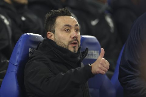 Brighton's head coach Roberto De Zerbi gestures as he takes his seat before the English Premier League soccer match between Brighton & Hove Albion and Tottenham Hotspur at the Amex stadium in Brighton, England, Thursday, Dec. 28, 2023. (AP Photo/Ian Walton)