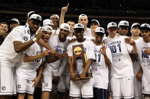 HOUSTON, TX - APRIL 04:  Kemba Walker #15 of the Connecticut Huskies holds the trophy as he and his team celebrate after defeating the Butler Bulldogs to win the National Championship Game of the 2011 NCAA Division I Men's Basketball Tournament by a score of 53-41 at Reliant Stadium on April 4, 2011 in Houston, Texas.  (Photo by Streeter Lecka/Getty Images)