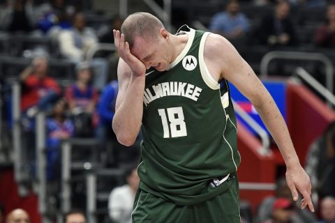 Milwaukee Bucks center Anzejs Pasecniks reacts after getting hit in the face during the second half of a preseason NBA basketball game against the Detroit Pistons, Sunday, Oct. 6, 2024, in Detroit. (AP Photo/Jose Juarez)