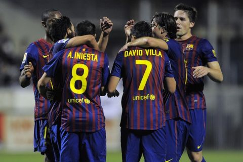 Barcelona's midfielder Andres Iniesta (L) is congratulated by his teammates after scoring during the Spanish Cup football match Hospitalet vs FC Barcelona on November 9, 2011 at the Estadio Olimpico municipal in Hospitalet near Barcelona.   AFP PHOTO / JOSEP LAGO (Photo credit should read JOSEP LAGO/AFP/Getty Images)