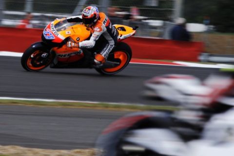 Repsol Honda MotoGP rider Casey Stoner (L) of Australia prepares to take a curve during the first practice session of the British motorcycling Grand Prix at Silverstone circuit, central England, June 10, 2011. REUTERS/Nigel Roddis (BRITAIN - Tags: SPORT MOTOR RACING)