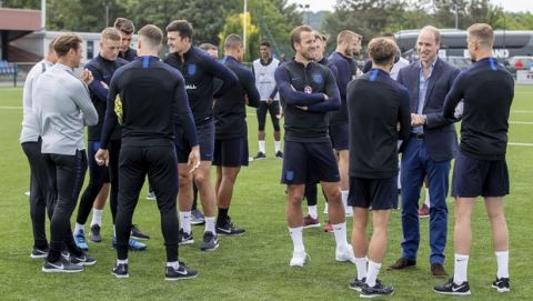 Britain's Prince William, second right, talks to members of the England soccer team, during his visit to the FA training ground to meet players ahead of their friendly match against Costa Rica, in Leeds, England, Thursday, June 7, 2018. (Charlotte Graham/Pool Photo via AP)