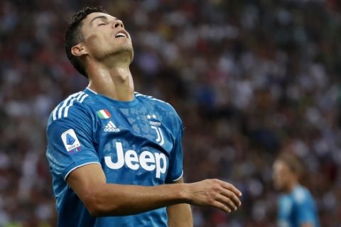 Juventus' Cristiano Ronaldo reacts after missing a chance to score during the Serie A soccer match between Parma and Juventus at the Tardini stadium, in Parma, Italy, Saturday, Aug. 24, 2019. (AP Photo/Antonio Calanni)