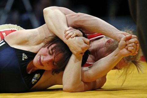 Maria Gurova of Russia (red) and Maria Prevolaraki of Greece compete at the women's 55kg Freestyle wrestling bronze medal match at the European Wrestling Championship in Belgrade March 8, 2012.  REUTERS/Ivan Milutinovic  (SERBIA - Tags: SPORT WRESTLING)