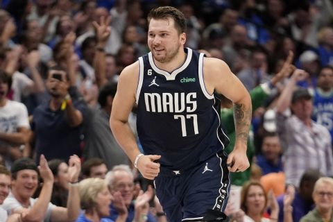 Dallas Mavericks guard Luka Doncic runs upcourt, smiling after sinking a 3-point basket during the first half of the team's NBA basketball game against the Memphis Grizzlies in Dallas, Saturday, Oct. 22, 2022. (AP Photo/Tony Gutierrez)