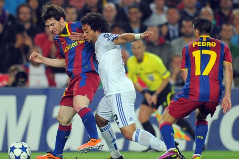 Barcelona's Argentinian forward Lionel Messi (L) vies with Real Madrid's Brazilian defender Marcelo (C) during the Champions League semi-final second leg football match between Barcelona and Real Madrid at the Camp Nou stadium in Barcelona on May 3, 2011. AFP PHOTO/LLUIS GENE (Photo credit should read LLUIS GENE/AFP/Getty Images)