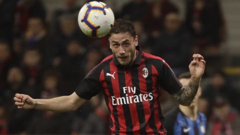 AC Milan's Davide Calabria heads the ball during a Serie A soccer match between AC Milan and Inter Milan, at the San Siro stadium in Milan, Italy, Sunday, March 17, 2019. (AP Photo/Luca Bruno)