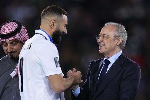 President of Real Madrid Florentino Perez Rodriguez, right, congratulates with Real Madrid's Karim Benzema during the awarding ceremony of the FIFA Club World Cup final at Prince Moulay Abdellah stadium in Rabat, Morocco, Saturday, Feb. 11, 2023. Real Madrid beat Al Hilal 5-3. (AP Photo/Manu Fernandez)