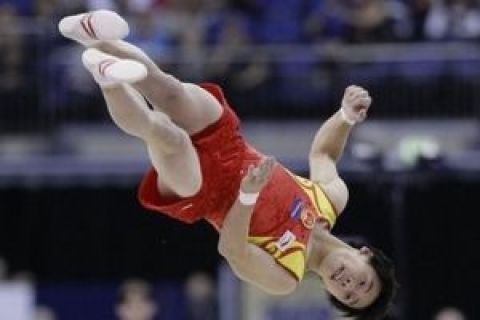 Zou Kai of China in action in the men's floor final during the World Gymnastics Championships at the O2 Arena in London, Saturday, Oct. 17, 2009 (AP Photo/Matt Dunham)