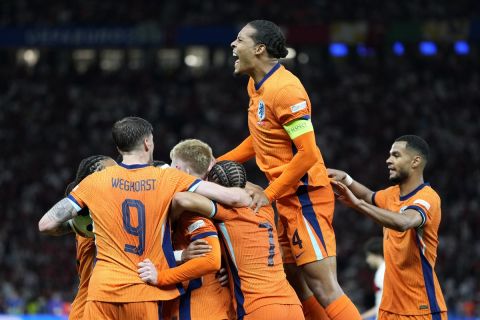 Virgil van Dijk of the Netherlands, up, celebrates after Stefan de Vrij of the Netherlands scored their sides first goal during a quarterfinal match between the Netherlands and Turkey at the Euro 2024 soccer tournament in Berlin, Germany, Saturday, July 6, 2024. (AP Photo/Antonio Calanni)