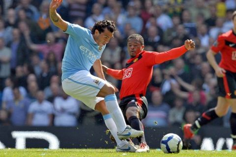 Manchester City's Argentinian striker Carlos Tevez (L) vies with Manchester United's French defender Patrice Evra during the English Premier League football match between Manchester City and Manchester United at the City Of Manchester Stadium in Manchester, north-west England on April 17, 2010. AFP PHOTO/ANDREW YATES  FOR EDITORIAL USE ONLY Additional licence required for any commercial/promotional use or use on TV or internet (except identical online version of newspaper) of Premier League/Football League photos. Tel DataCo +44 207 2981656. Do not alter/modify photo. (Photo credit should read ANDREW YATES/AFP/Getty Images)