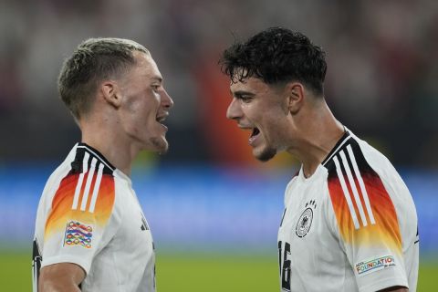 Germany's Aleksandar Pavlovic, right, celebrates with Florian Wirtz after scoring his side's fourth goal during the UEFA Nations League soccer match between Germany and Hungary at the Merkur Spiel-Arena in Dusseldorf, Germany, Saturday, Sept. 7, 2024. (AP Photo/Michael Probst)