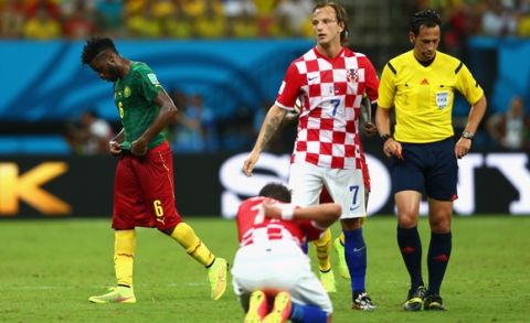 MANAUS, BRAZIL - JUNE 18:  Alex Song of Cameroon walks off the field after receiving a red card during the 2014 FIFA World Cup Brazil Group A match between Cameroon and Croatia at Arena Amazonia on June 18, 2014 in Manaus, Brazil.  (Photo by Clive Brunskill/Getty Images)