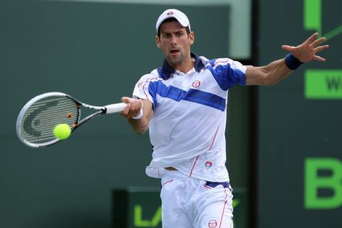 KEY BISCAYNE, FL - APRIL 01:  Novak Djokovic of Serbia hits a forehand return against Mardy Fish during their semifinal match at the Sony Ericsson Open at Crandon Park Tennis Center on April 1, 2011 in Key Biscayne, Florida.  (Photo by Al Bello/Getty Images)