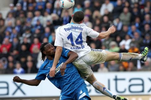 Hoffenheim's defender Isaac Vorsah (L) and  Schalke's Greek defender Kyriakos Papadopoulos (R) vie for the ball during the German first division Bundesliga football match TSG 1899 Hoffenheim vs FC Schalke 04 in Sinsheim, Germany, on April 1, 2012. AFP PHOTO / DANIEL ROLAND

RESTRICTIONS / EMBARGO - DFL LIMITS THE USE OF IMAGES ON THE INTERNET TO 15 PICTURES (NO VIDEO-LIKE SEQUENCES) DURING THE MATCH AND PROHIBITS MOBILE (MMS) USE DURING AND FOR FURTHER TWO HOURS AFTER THE MATCH. FOR MORE INFORMATION CONTACT DFL. (Photo credit should read DANIEL ROLAND/AFP/Getty Images)