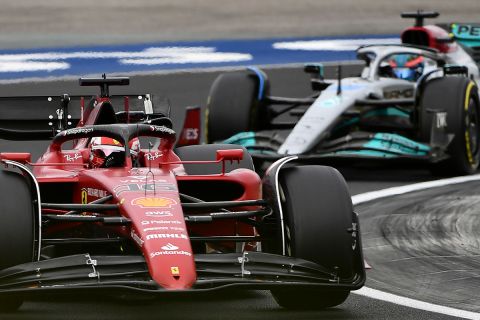 Ferrari driver Charles Leclerc of Monaco steers his car followed by Mercedes driver George Russell of Britain during the Hungarian Formula One Grand Prix at the Hungaroring racetrack in Mogyorod, near Budapest, Hungary, Sunday, July 31, 2022. (AP Photo/Anna Szilagyi)