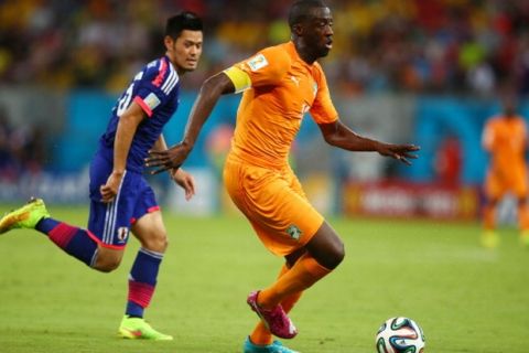 RECIFE, BRAZIL - JUNE 14: Yaya Toure of the Ivory Coast controls the ball against Hotaru Yamaguchi of Japan during the 2014 FIFA World Cup Brazil Group C match  between the Ivory Coast and Japan at Arena Pernambuco on June 14, 2014 in Recife, Brazil.  (Photo by Julian Finney/Getty Images)