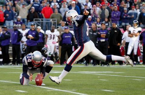 FOXBORO, MA - OCTOBER 17:  Stephen Gostkowski #3 of the New England Patriots kick the game winning field goal as Joe Flacco #5 of the Baltimore Ravens watches from the sidelines at Gillette Stadium on October 17, 2010 in Foxboro, Massachusetts. The Patriot won 23-20 in overtime.  (Photo by Jim Rogash/Getty Images)