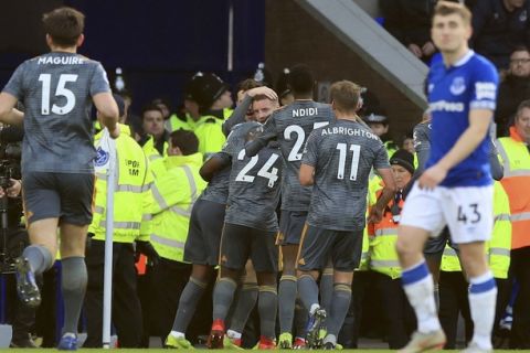 Leicester City's Jamie Vardy looks out as he is mobbed by team-mates after scoring his sides first goal of the game against Everton, during their English Premier League soccer match at Goodison Park in Liverpool, England, Tuesday Jan. 1, 2019. (Peter Byrne/PA via AP)