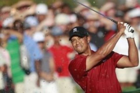 Tiger Woods hits from the sand on the 18th hole during the final round of The Tour Championship golf tournament at East Lake Golf Club in Atlanta Sunday, Sept. 27, 2009. Woods finished another big year by winning the FedEx Cup and its $10 million bonus. (AP Photo/Dave Martin)