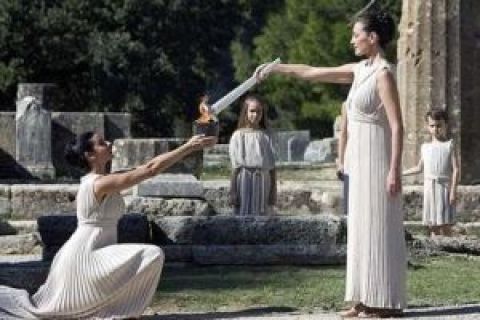 Greek actress Maria Nafpliotou, playing the role of high priestess, right, lights the Olympic flame for the 2010 Winter Olympic Games in Vancouver during a rehearsal ceremony at the ancient stadium in Ancient Olympia, Greece, Wednesday, Oct. 21, 2009.  The official Olympic flame ceremony for the 2010 Winter Olympic Games in Vancouver will be held on Thursday in Ancient Olympia.  THE CANADIAN PRESS/Jonathan Hayward