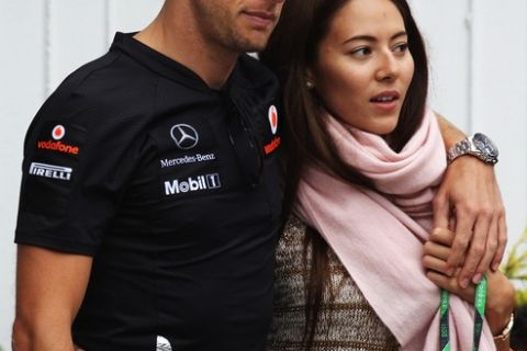 BUDAPEST, HUNGARY - JULY 31:  Jenson Button of Great Britain and McLaren and his girlfriend Jessica Michibata arrive in the paddock and he prepares to race in his 200th Grand Prix during the Hungarian Formula One Grand Prix at the Hungaroring on July 31, 2011 in Budapest, Hungary.  (Photo by Mark Thompson/Getty Images)