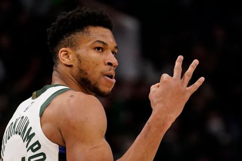 Milwaukee Bucks' Giannis Antetokounmpo reacts after making a three-point basket during the second half of an NBA basketball game against the Philadelphia 76ers Thursday, Feb. 17, 2022, in Milwaukee. The 76ers won 123-120. (AP Photo/Morry Gash)