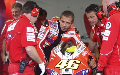 Ducati MotoGP rider Valentino Rossi of Italy checks his bike before the third free practice session at the Czech Grand Prix in Brno August 13, 2011.   REUTERS/Petr Josek (CZECH REPUBLIC - Tags: SPORT MOTOR RACING)