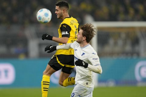 Dortmund's Yan Couto, left, and Hoffenheim's Jacob Bruun Larsen vie for the ball during the German Bundesliga soccer match between Borussia Dortmund and TSG Hoffenheim at the Signal-Iduna Park in Dortmund, Germany, Sunday, Dec. 15 2024. (AP Photo/Martin Meissner)