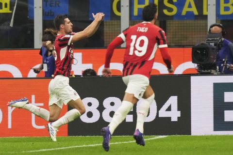 AC Milan's Matteo Gabbia, centre, celebrates after scoring his side's second goal during the Serie A soccer match between Inter Milan and AC Milan at the San Siro stadium in Milan, Italy, Sunday, Sept.22, 2024. (AP Photo/Luca Bruno)